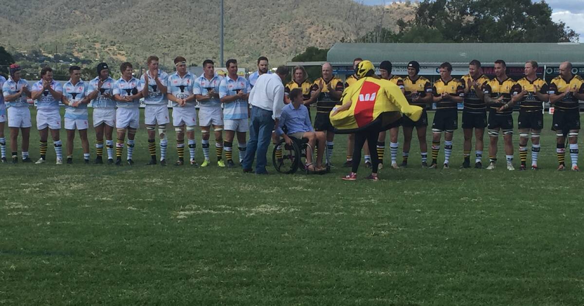 Special moment: Harrison Frear is clapped out by the Quirindi and Pirates players as he delivers the game ball.