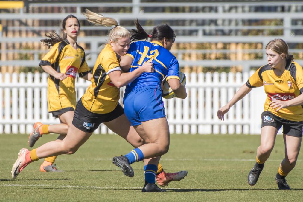 Driving defence: Playing for NSW Country, Piper Rankmore looks to stop this City player's run during Sunday's clash in Tamworth. Photo: Peter Hardin