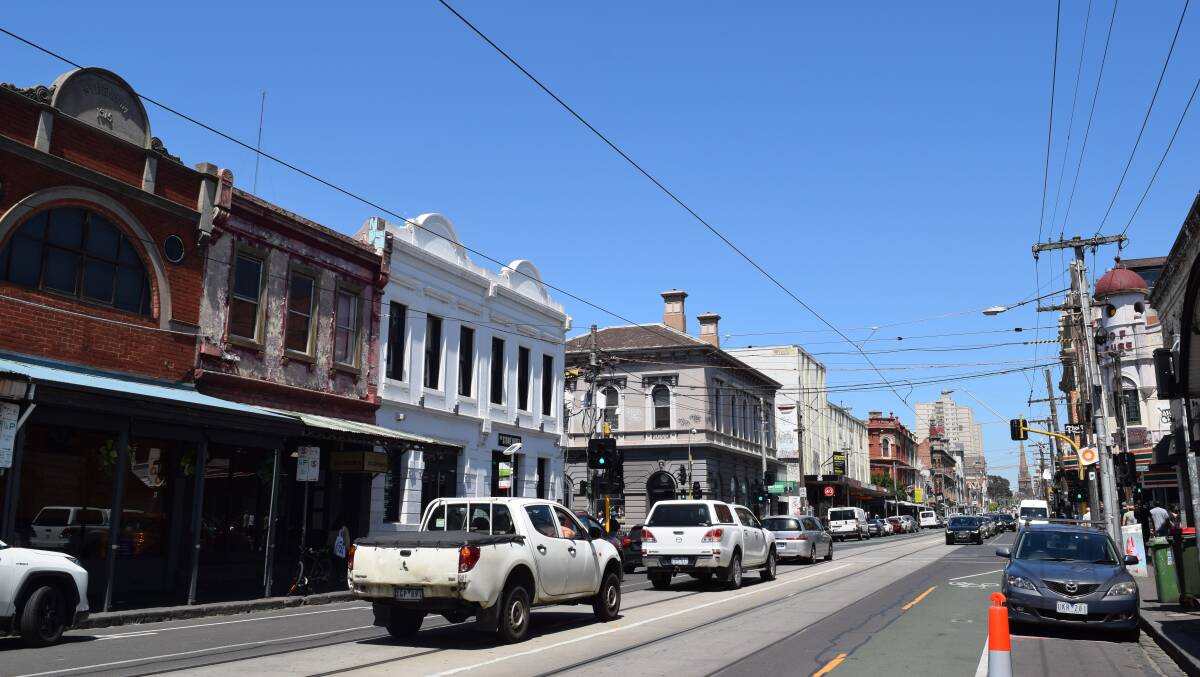 Melbourne's famous Brunswick Street shopping strip had a quiet first day open after lockdown rules banning retail and hospitality lifted last night. Picture: Sophie Raynor