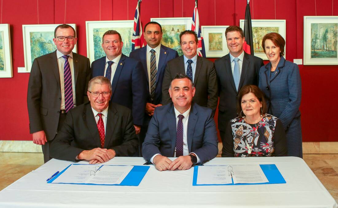 Deputy premier John Barilaro signs the memorandum of understanding alongside Regional Cities NSW chair Col Murray.