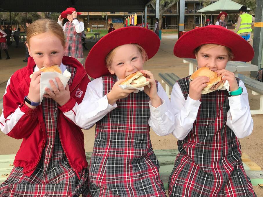 Gunnedah South Public School students dig into some bacon and egg rolls before hitting the books for NAPLAN. Photo: supplied