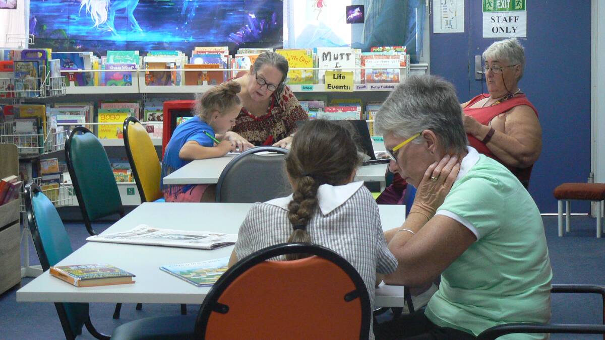 Gunnedah seniors work with students to lend a helping hand with the children's reading skills. Photo: supplied