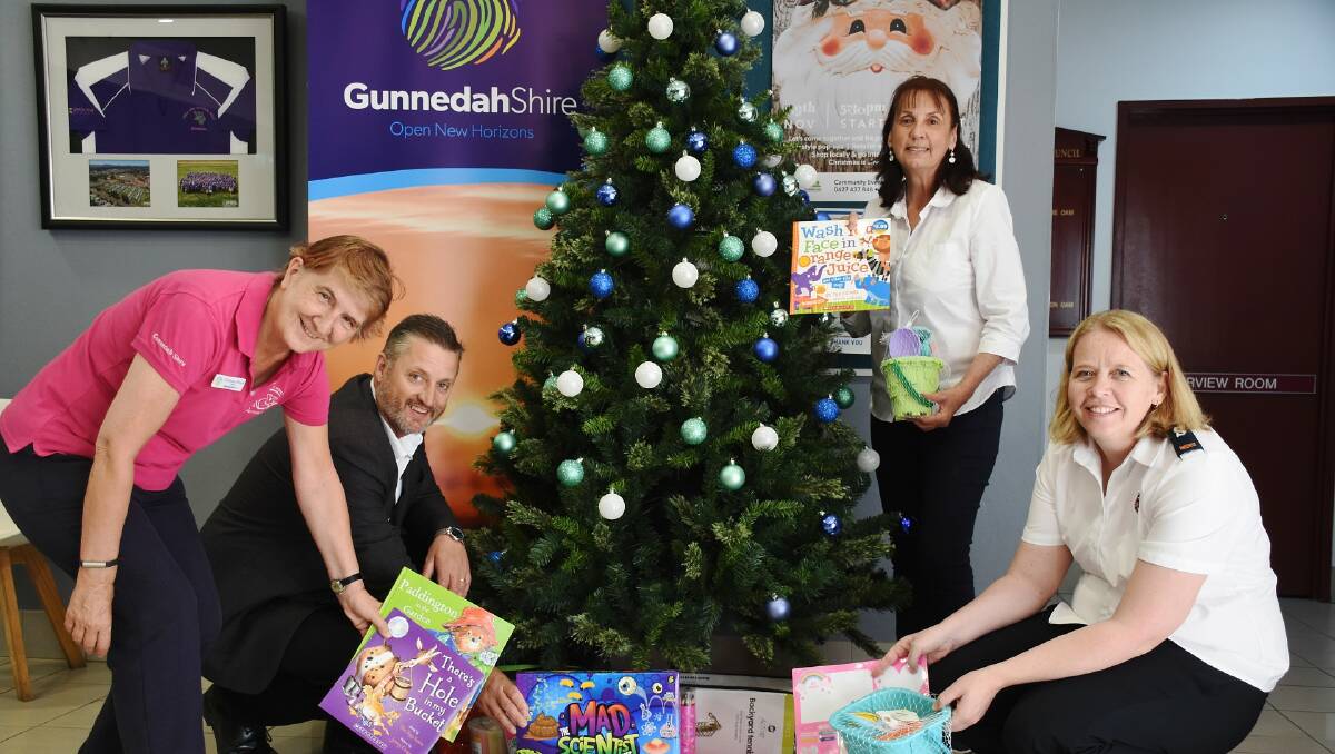 Mayor Jamie Chaffey, Gunnedah librarian Christiane Birkett, Marika Wallis from the Salvation Army, and Gunnedah Shire Council community and social planner Debra Hilton with presents for the Christmas tree at Councils Elgin Street office. Photo: supplied