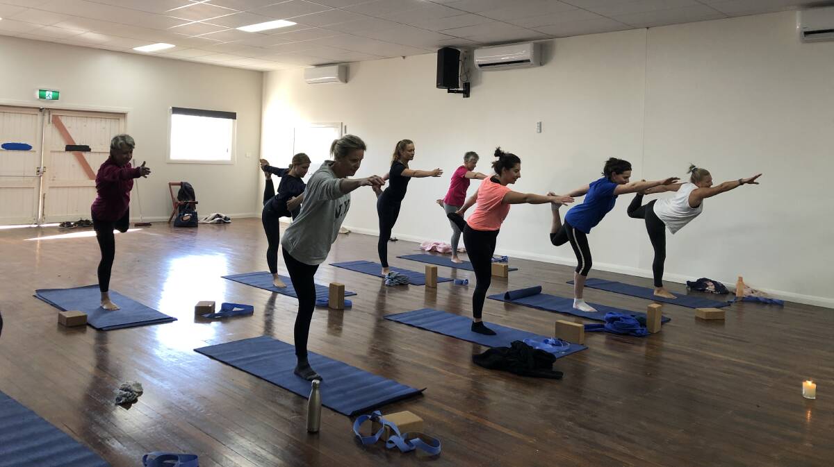 Attendees of the free yoga classes at Mullaley Hall show off their yoga moves. Photo: Amelia Smith