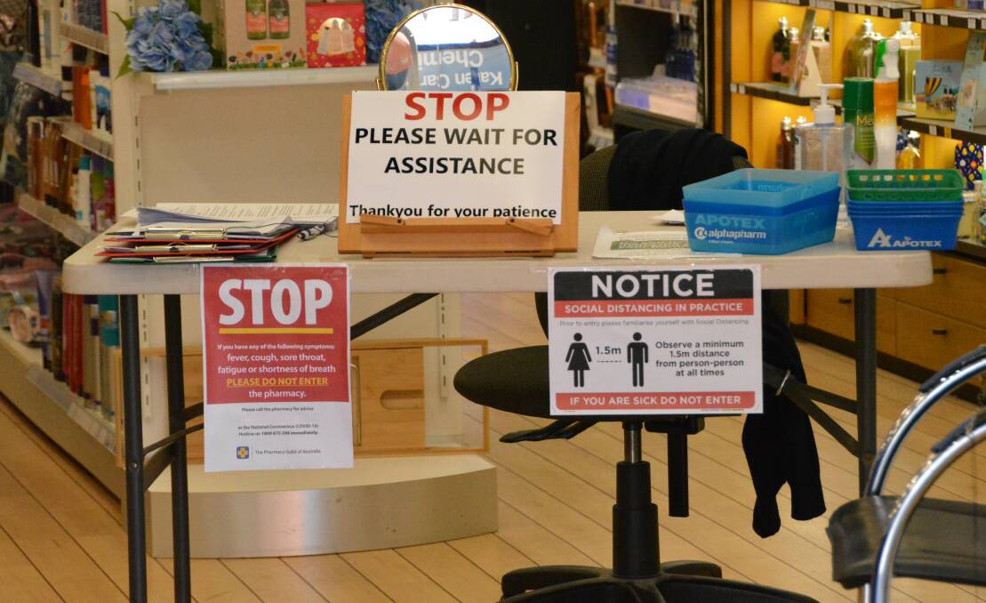 Karen Carter Chemist have set up a table inside its doors to adhere to the government's new rules. Photo: Jessica Worboys