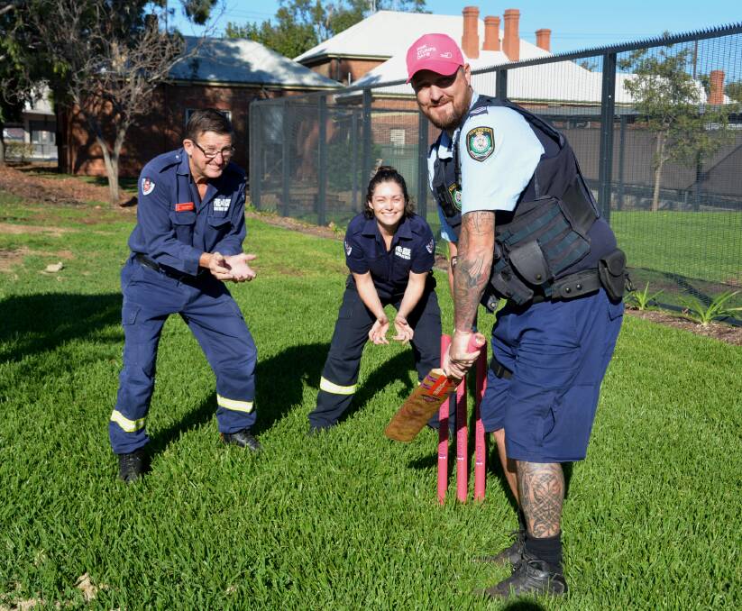 Fire and Rescue deputy captain Paul Hartley and member Monica Bentham with Gunnedah police's Damien Wood getting ready for the big match. Photo: Jessica Worboys