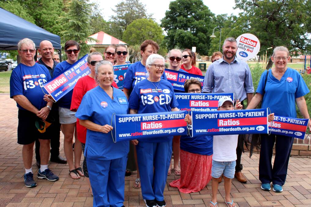 RATIO RALLY: Local nurses and midwives, including NSWNMA secretary Heather Franks (front, centre), display their campaign banners in Wolseley Park. Photo: Jessica Worboys