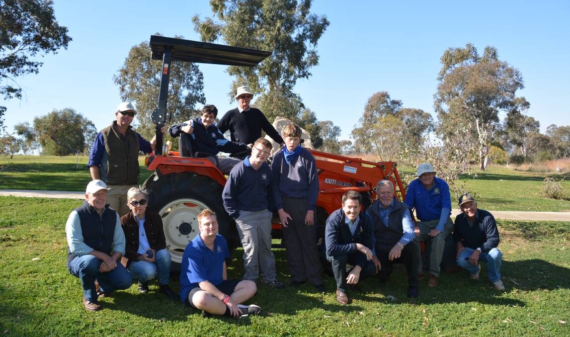 Members of GULG, students of GS Kidd Memorial School, and Tamworth MP Kevin Anderson in front of the new tractor at Pensioner's Hill. Photo: Jessica Worboys