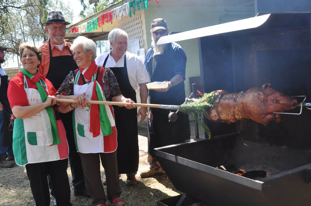 Chefs basting the whole roast pork at Porchetta in 2013.