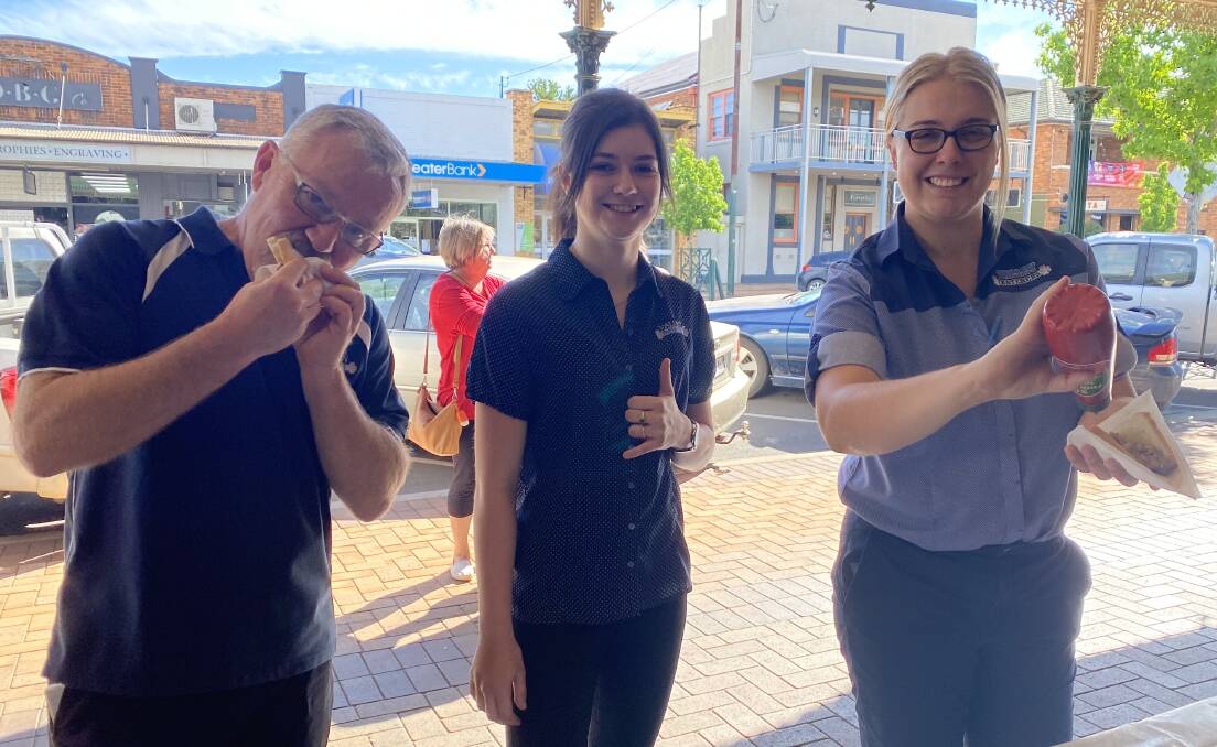 Valley Fasteners' Craig Kolstad, Lilly Turner and Amber Thomas tuck into a sausage sanga. Photo: supplied