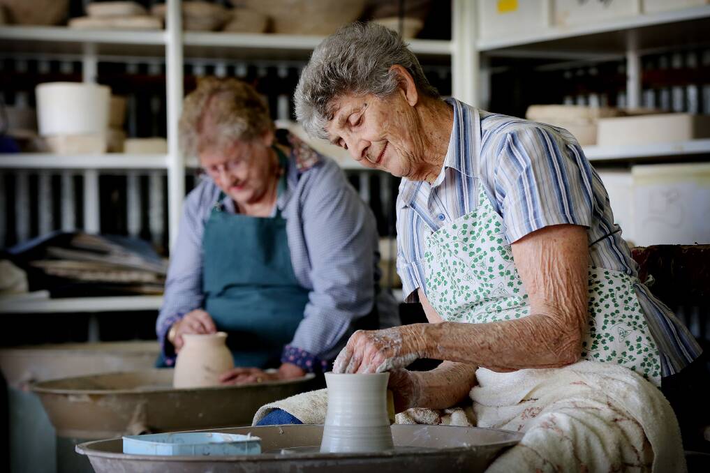 HARD AT WORK: Gunnedah Pottery Club's Anne Pickett and Pat Tobin working on some vessels. Photo: supplied