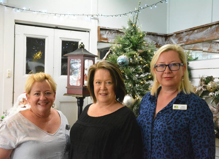 CHRISTMAS CHEER: Gunnedah Chamber of Commerce's Tracie Finlay and Juliana McArthur with Goodness and Gracious' Leanne Smith at the new Christmas store. Photo: Jessica Worboys
