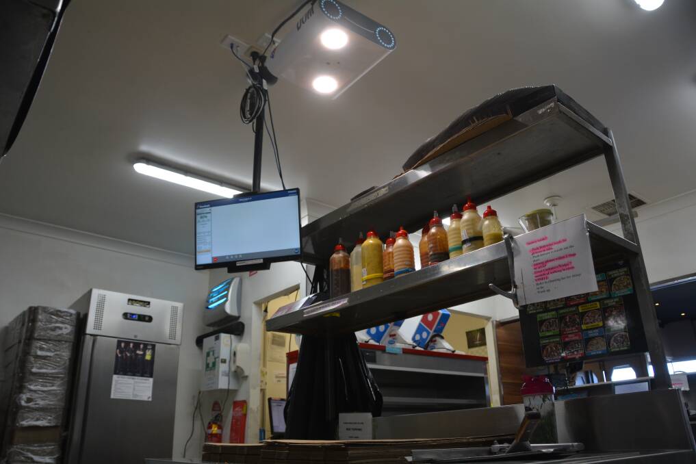 The artificial intelligence takes an image of the pizza on the bench below and a score comes up on the screen to determine if it is fine to be given to the customer. Photo: Jessica Worboys