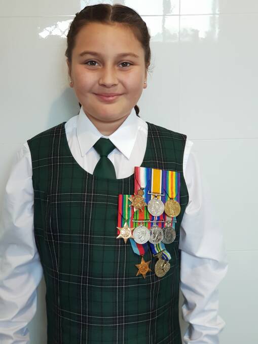 Curlewis Public School student Jayla Suey marched proudly wearing her Great Great Grandfather's WWI badges. Photo: Jamee Ovington