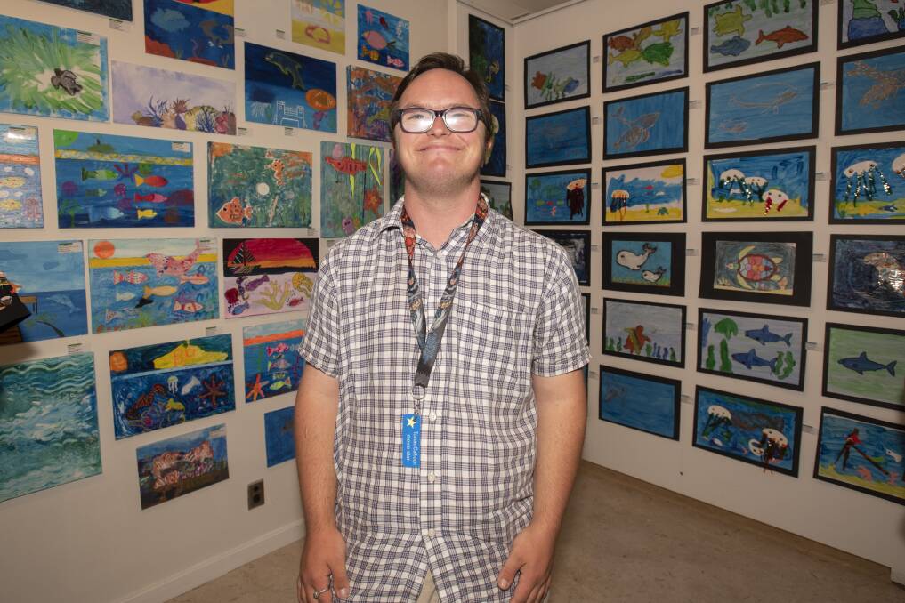FROM THE ART: Tomas Calhoun with some of the piece on display in the Challenge art show at Ray Walsh House. Photo: Peter Hardin 171219PHB071