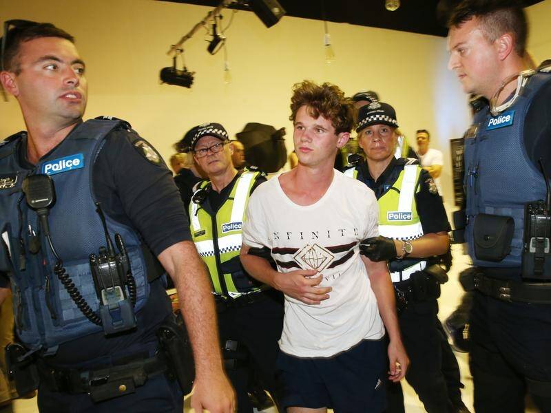 The teenager (C) who cracked an egg on Senator Fraser Anning's head has admitted it wasn't wise.