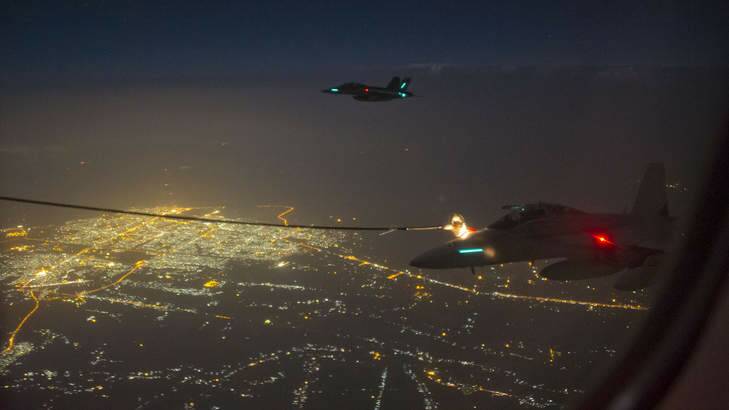 Two Australian FA-18F Super Hornet aircraft conduct air-to-air refuelling during their first mission in Iraq. Photo: Supplied