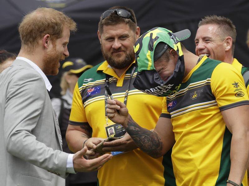 A laughing Prince Harry wouldn't sign the budgie smugglers for three Aussie Invictus competitors.