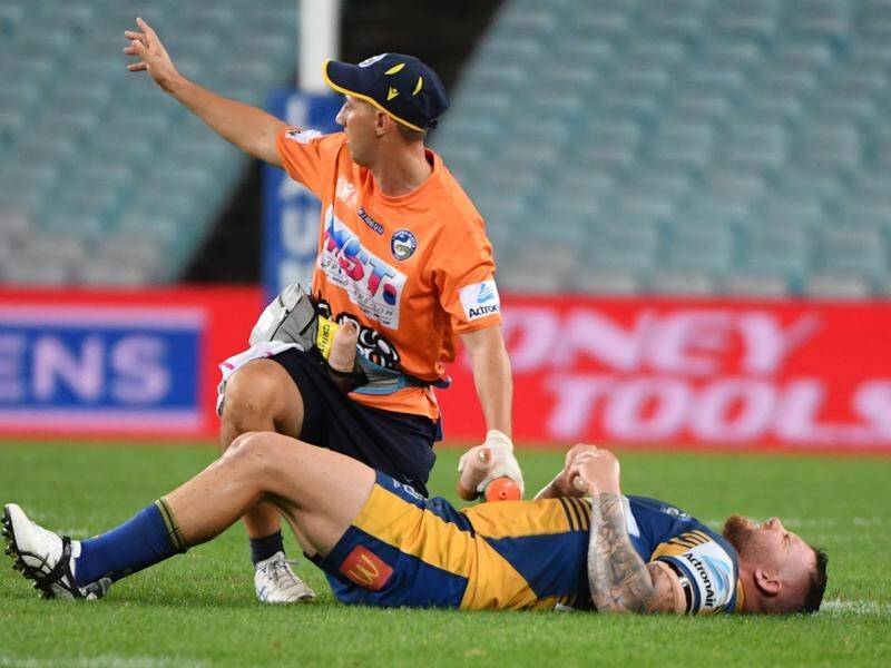Parramatta's Nathan Brown being treated for a hip injury during the match against the Bulldogs.