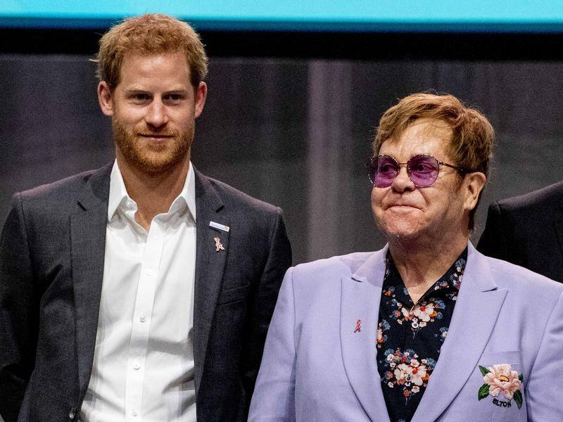 Elton John says he flew Harry and Meghan on a private jet to Nice to protect them from the media.