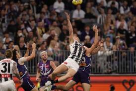 Magpie Brody Mihocek flying through the air in their dramatic draw against the Dockers. (Richard Wainwright/AAP PHOTOS)