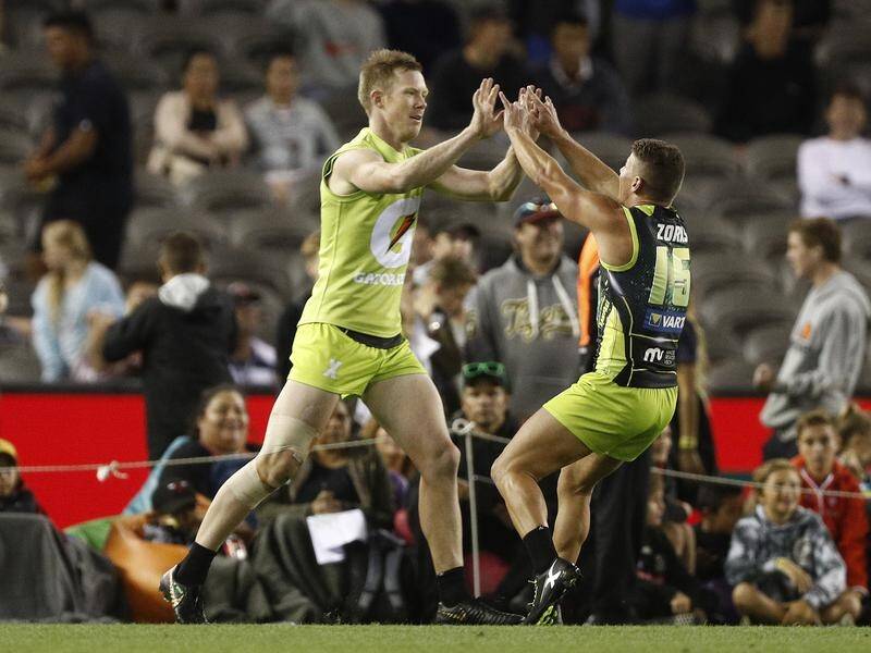 Jack Riewoldt (left) hails the winning goal in the AFLX final between Team Rampage and the Flyers.