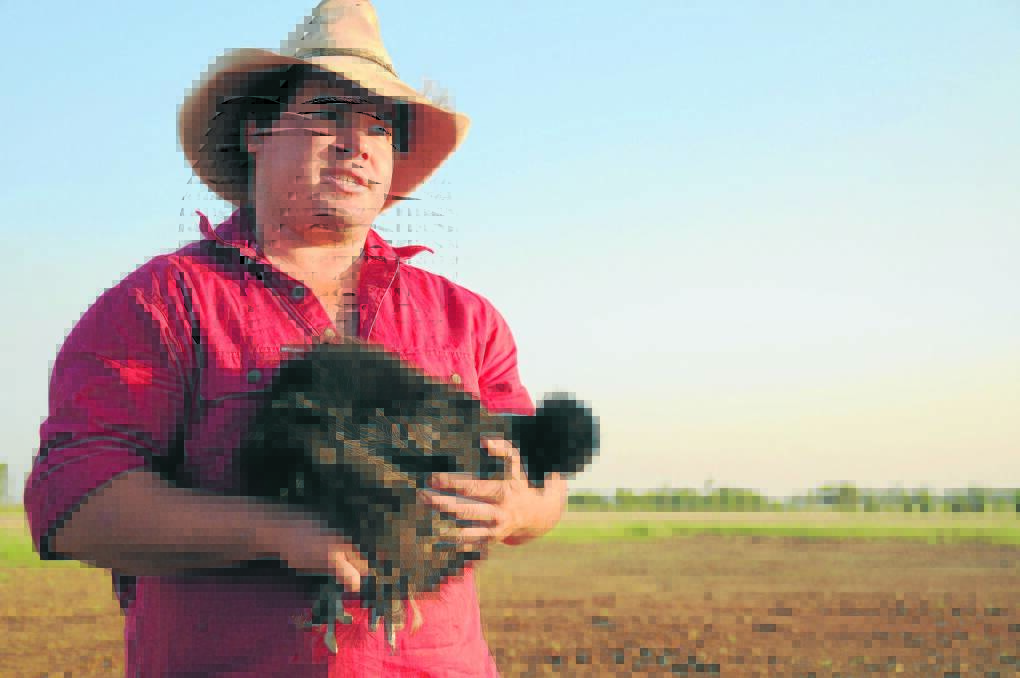 Kelvin farmer Cameron Ward with a silkie chicken on the sight of his proposed new poultry operation. 