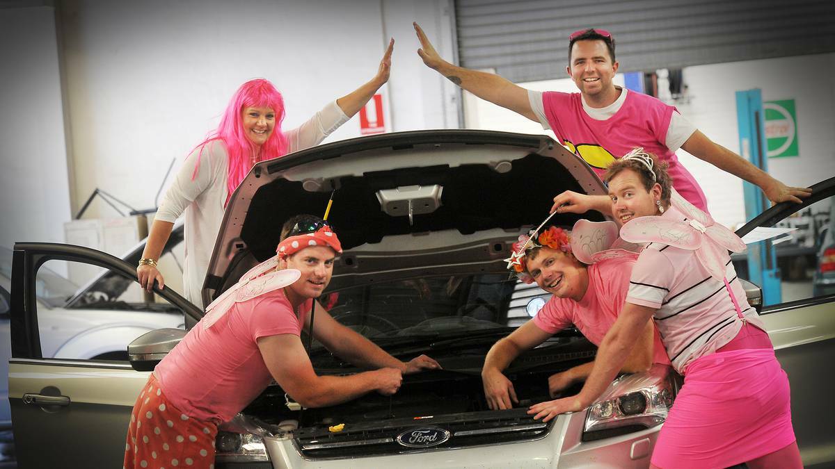 DOUBLE TAKE: The service team at JT Fossey were "in the pink" yesterday to raise money for breast cancer research. At the back are Kylie Watts and Hugh Locke, in the front, from left, Dennis Johnson, Matt Gardner and Mat McDonald. Photo: Gareth Gardner 071014GGA04