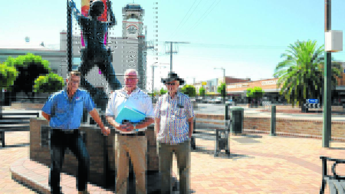 Speaking up for mining: (From left) Stripes Group of Companies managing director Jamie Chaffey, Ewing Real Estate’s Don Ewing and James Farquhar of the Mackellar Motel in front of the monument to fallen miners which demonstrates the shire’s long history with mining.