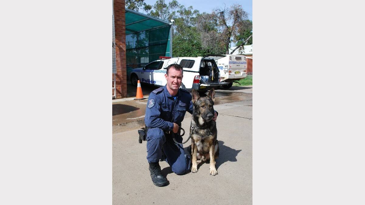 Constable Scott Curtin from the State Protection Group, based in Sydney, with four-year-old police dog, Finn, at the Gunnedah Police Station this morning.