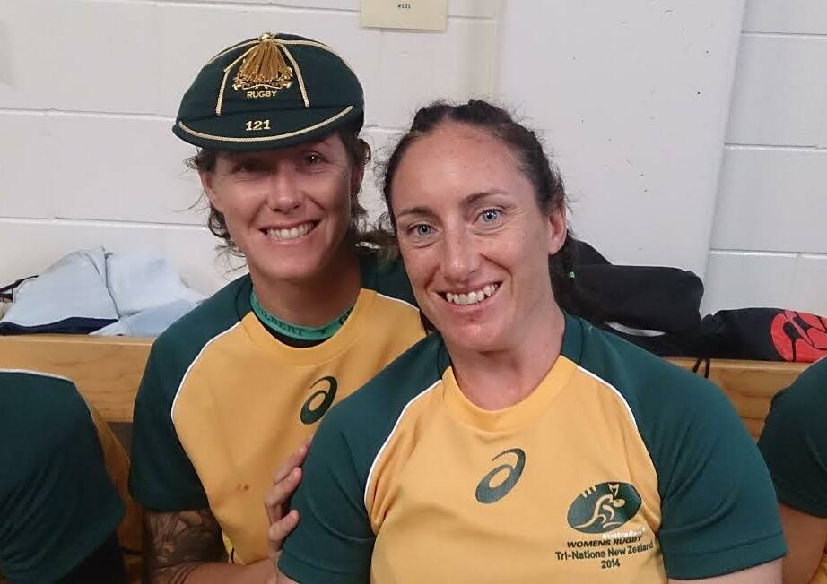 Australian rugby players Brooke Saunders kicks back with team-mate Tricia Brown after a Wallaroos match.