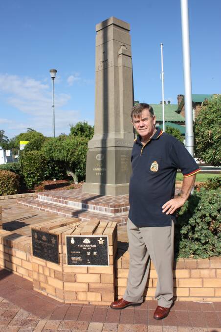 Gunnedah RSL Sub-branch secretary Kerry Bee at the cenotaph which has 13 new plaques. He is standing next to the plaque commemorating the Vietnam War in which he served in the navy.
