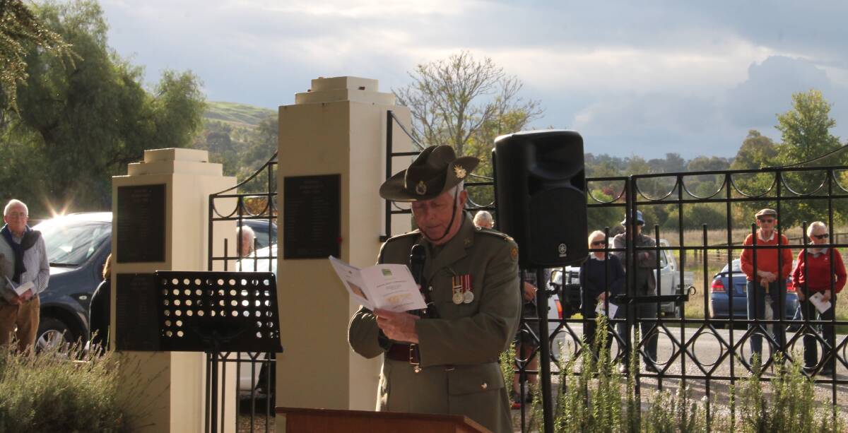 Father Bernie Hennessy as an army chaplain, pictured at the Memorial Gates in Jugiong during a commemoration service. Photo: Harden Murrumburrah Express.