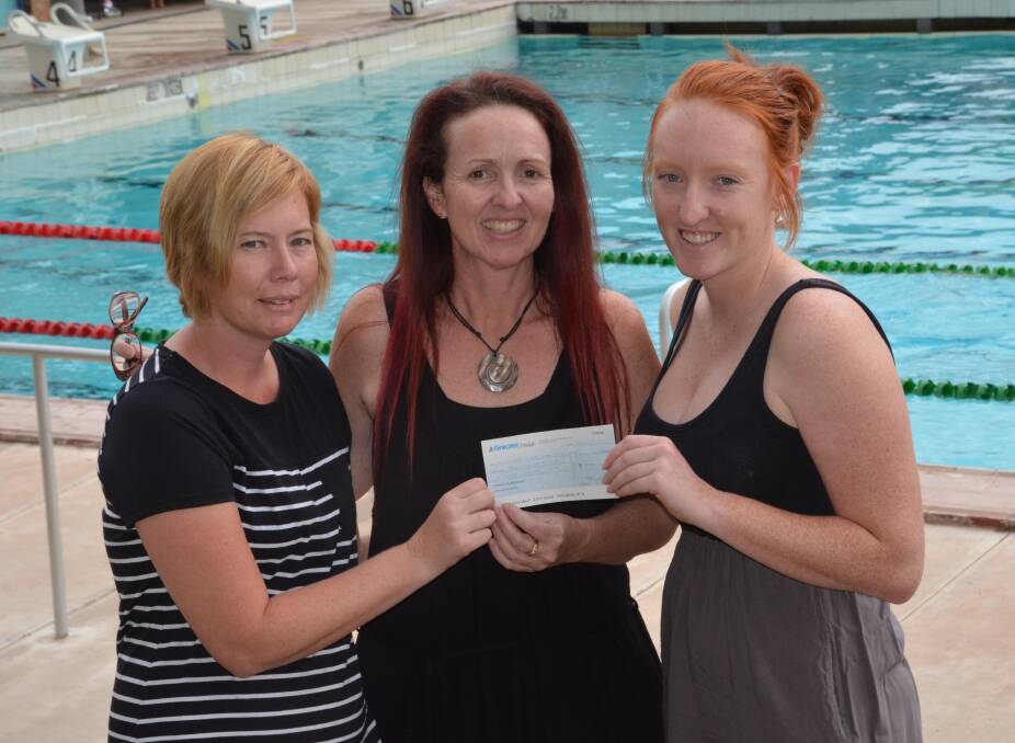 Molly Dawson, right, and Emma Gallen, a swimming club mum who has also helped Natalie with fund-raising, presented a cheque for $2500 to Natalie Walters-Hopwood representing the Luke family whose daughter Ava is receiving treatment for Leukaemia.