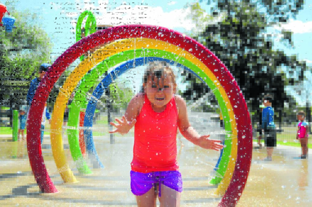 Rihanna Parry runs through a rainbow at Lake Keepit. Photo: Namoi Valley Independent, Marie Low.