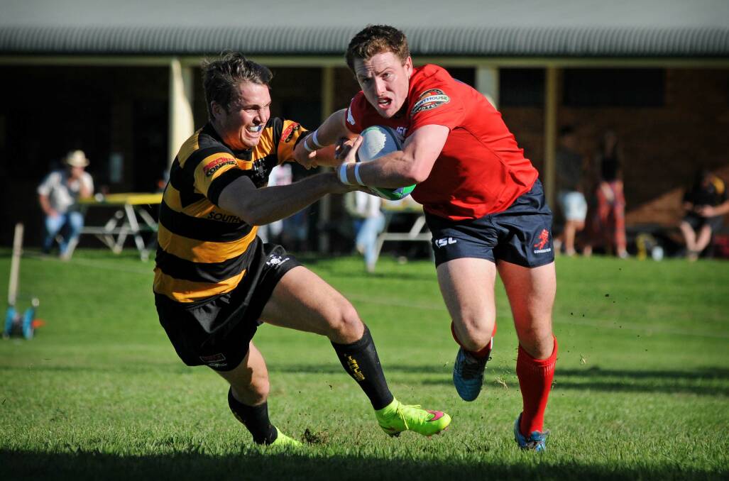 Red Devils’ Oscar Hunt brushes past a Pirates defender during last weekend’s round one Central North Rugby Union clash in Gunnedah.Photo courtesy Sarah Hickey