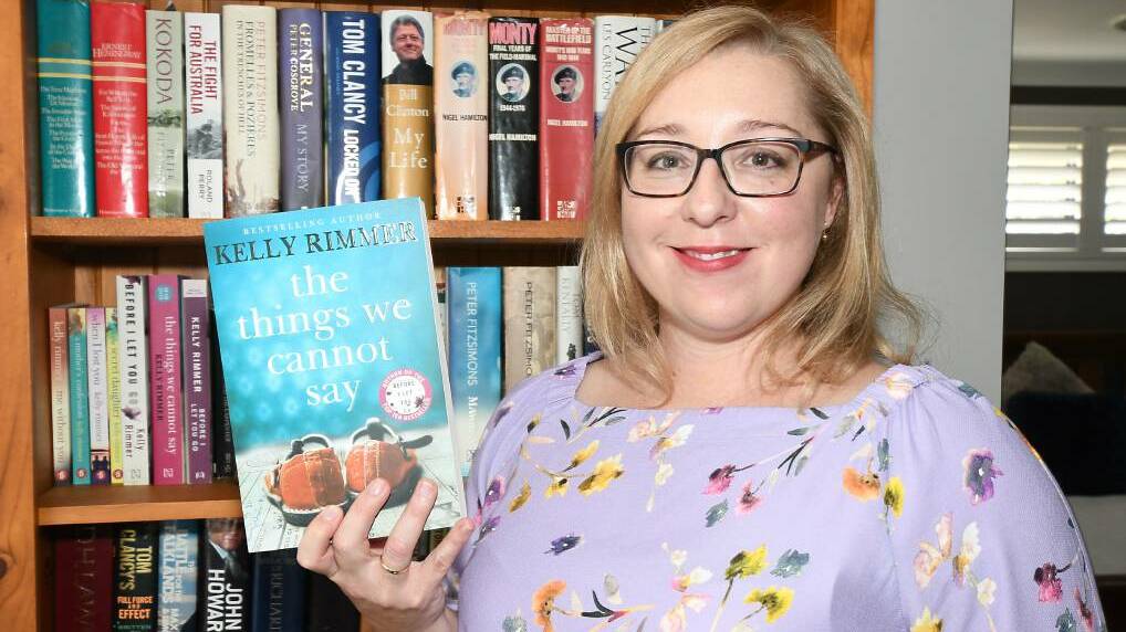 Kelly Rhymer with her book "The Things We Cannot Say".