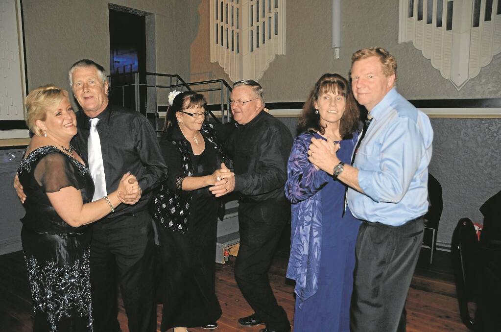 DANCE group the “Gunnedah Stray Cats” filled a table at the ball and danced the night away. From left, Julie and Wayne Smee, Raema and Norm Wilby and Liz and Glen Bailey.
